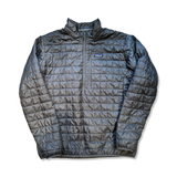 Grey Patagonia men's Nano Puff pullover jacket with a quilted design and half zipper, front view against a white background.