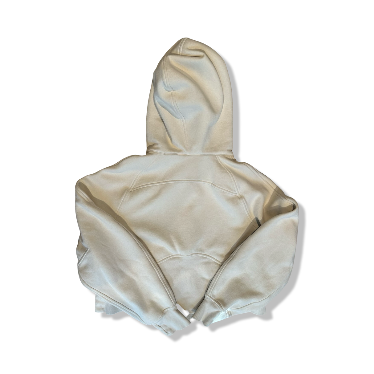 Offwhite hoodie från Lululemon i dammodell storlek XS, fotograferad bakifrån mot en vit bakgrund.
