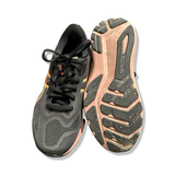 Black women's running shoes Asics GT-1000 14, shown from the front and with the outsole facing upward against a white background.