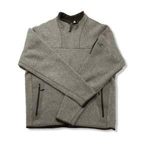 Beige Arc'teryx men's fleece cardigan with zipper, front view against a white background.