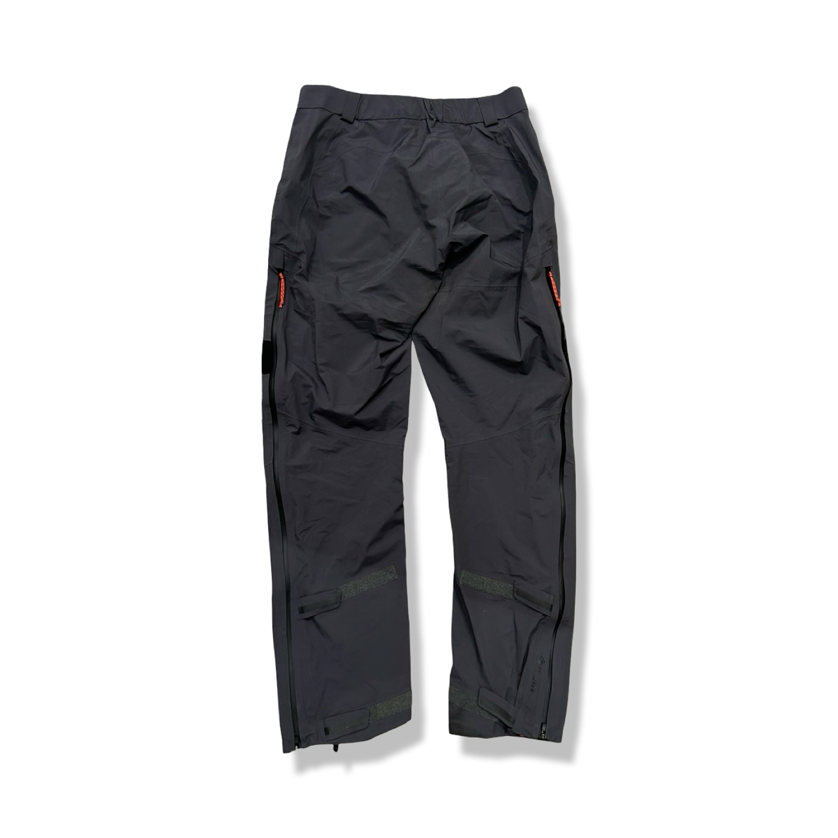 Back view of a grey Peak Performance women's shell pants against a white background.