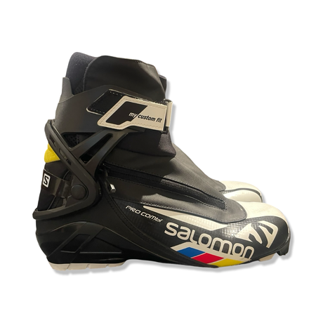 White and black Salomon Pro Combi men's boots, side view against a white background.