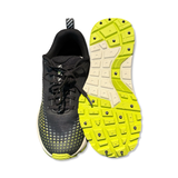 Black and yellow Icebug NEWRUN W BUGrip women's running shoe with a studded sole, photographed from the front and bottom against a white background.