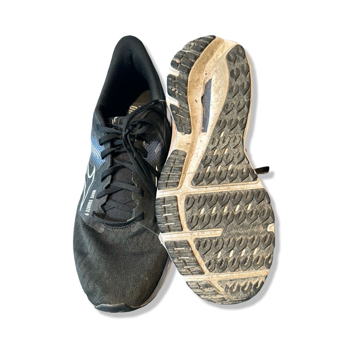 Black Mizuno running shoes for men with a patterned outsole, photographed against a white background.