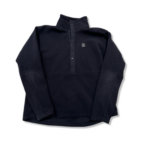 Black Haglöfs Mora mid women's fleece sweater with snap buttons, front view against a white background.