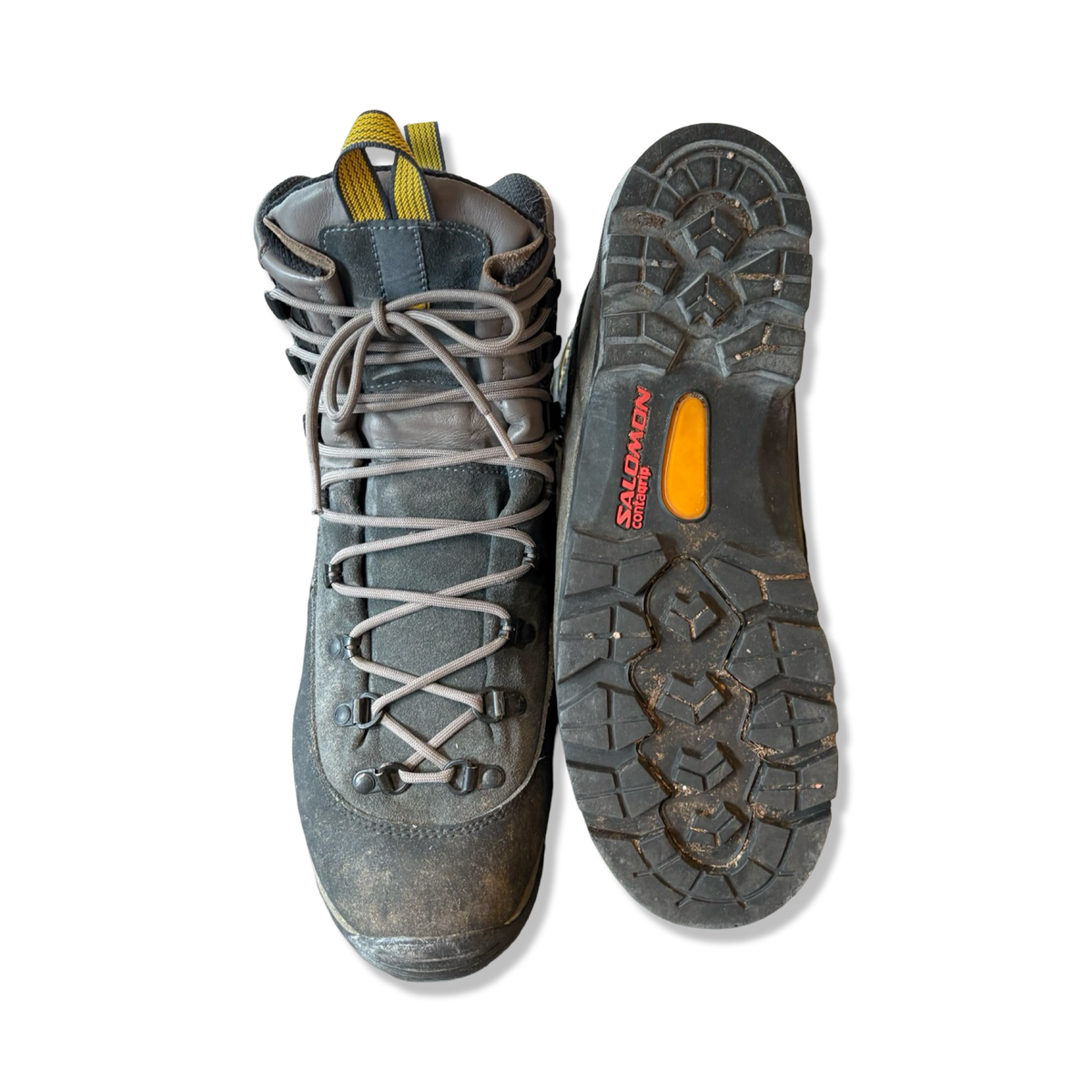 Grey men's Salomon hiking boots in suede and synthetic, shown top-down with one boot lying flat and the sole visible against a white background.