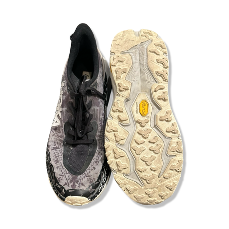 Black Hoka Speedgoat 6 men's running shoes, viewed from above with the sole facing up against a white background.