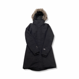 Black The North Face women's down jacket with a fur-trimmed hood, front view against a white background.