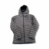Grey Norröna women's Tamok Light Weight Down750 hooded jacket, front view against a white background.