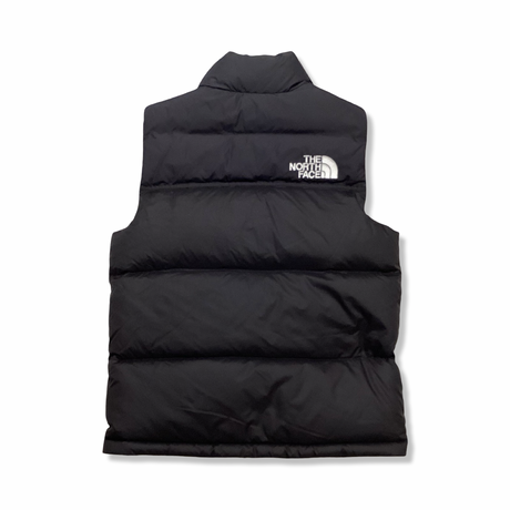 Back view of a black The North Face kids' vest against a white background.