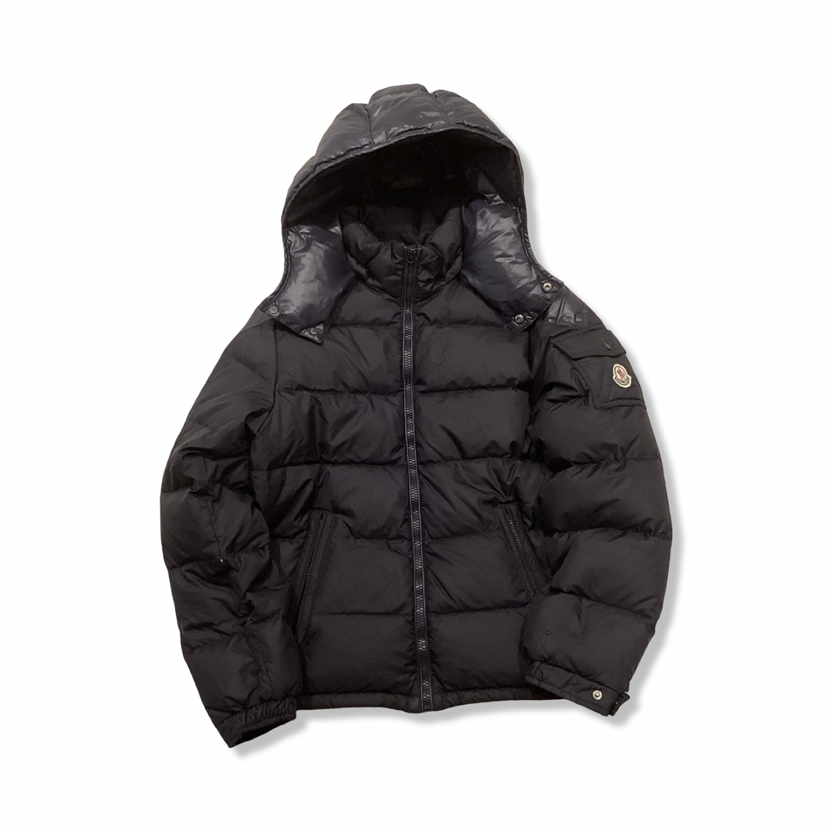 Black Moncler hooded down jacket with zipper, front view against a white background.