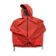 Red Nike women's zipped training jacket with hood, front view against a white background.