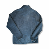 Baksidan av blå fleececardigan Lundhags Flok Wool för dam i storlek M, visad mot vit bakgrund.