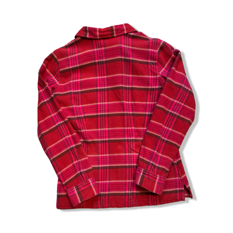 Back view of a red Patagonia women's flannel shirt against a white background.