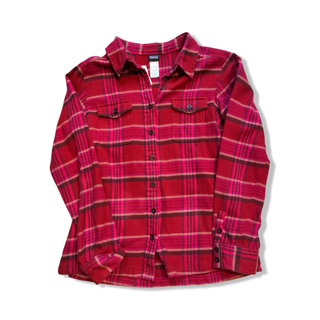 Red flannel Patagonia women's shirt with plaid pattern and chest pockets, front view against a white background.