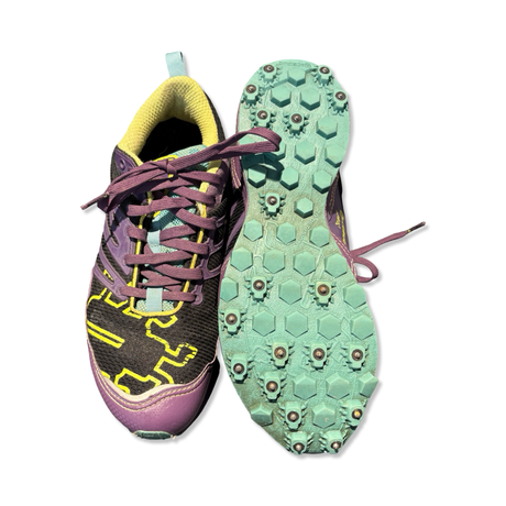 Purple and black Icebug women's running shoes with studded soles, shown against a white background.