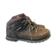 Brown women's hiking boots from Timberland with lacing, photographed from the side against a white background.