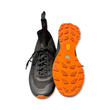 Black Arc'teryx Vertex U women's trail running shoe with orange Vibram sole, shown from above against a white background.