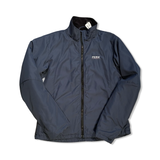 Blue Peak Performance men's synthetic jacket with high collar and zipper, front view against a white background.