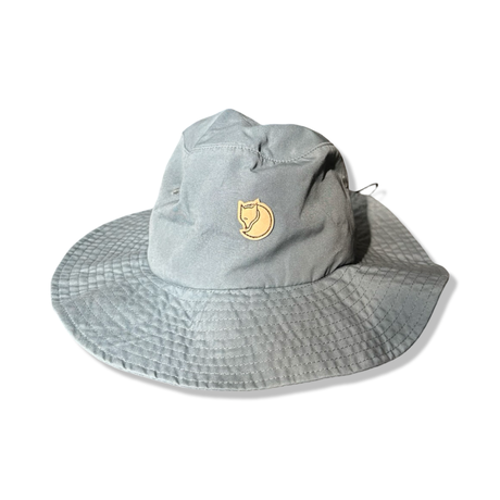 Blue Fjällräven Hatfield unisex sun hat with a wide brim, photographed from the front against a white background.
