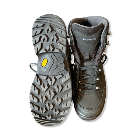 Black women's Lowa Renegade GTX Mid hiking boots, shown with one sole and the front against a white background.