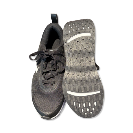 Black Nike Promina women's running shoes, shown from above with one shoe's outsole visible against a white background.