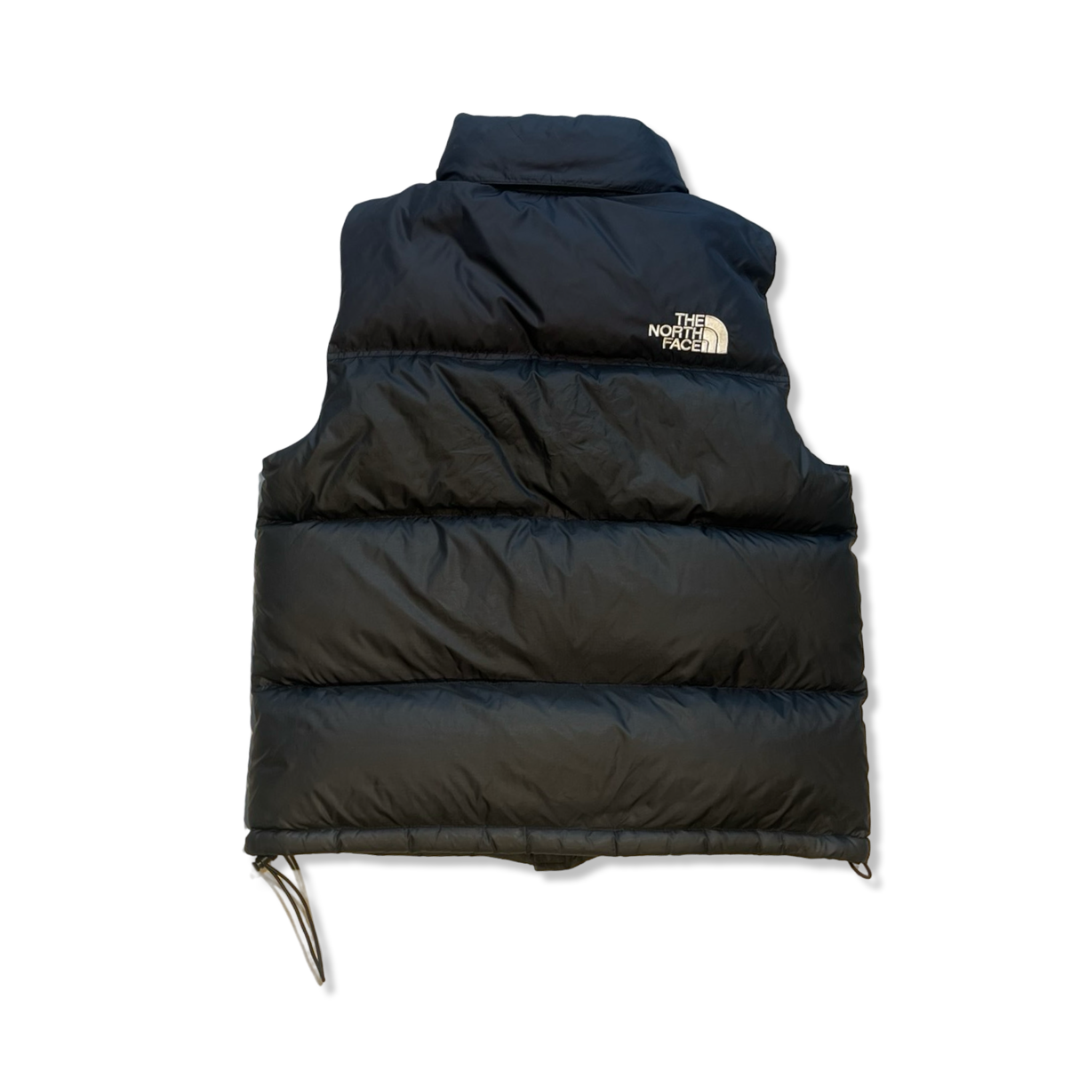 Svart quiltad vadderad väst från The North Face med hög krage och logotyp, fotograferad bakifrån mot vit bakgrund.