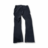 Back view of a pair of black Peak Performance women's ski pants against a white background.