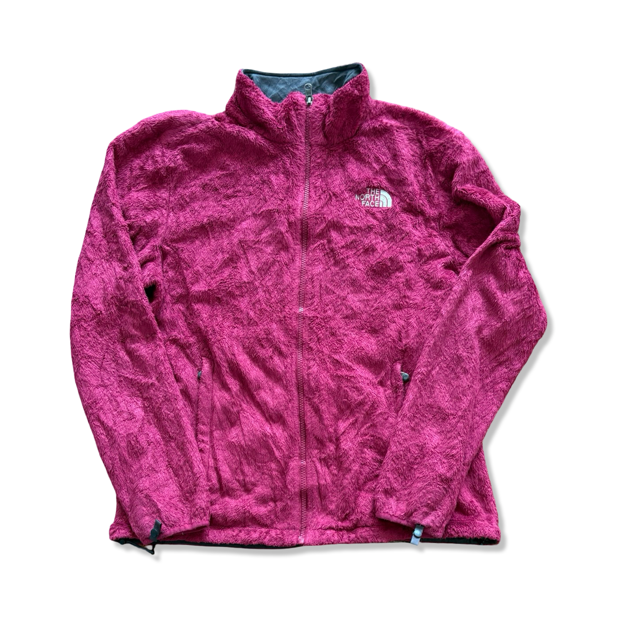 Rosa fleececardigan för dam från The North Face med dragkedja, fotograferad framifrån mot vit bakgrund.