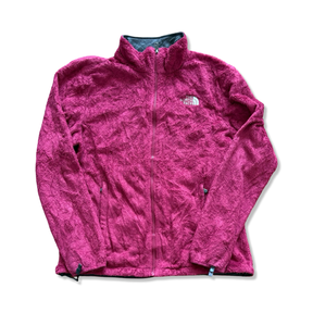 Rosa fleececardigan för dam från The North Face med dragkedja, fotograferad framifrån mot vit bakgrund.
