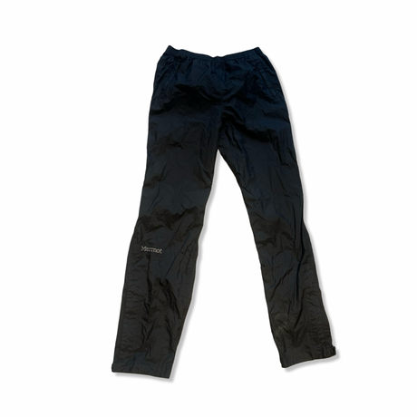 Black Marmot rain pants in crinkled fabric with an elastic waist, shown against a white background.