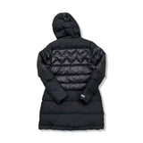 Back view of a black Mountain Works women's hooded puffer jacket against a white background.