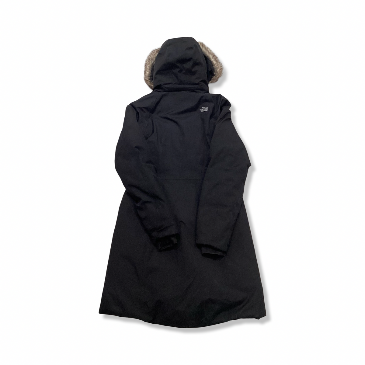 Back view of a black The North Face women's down jacket with a fur-trimmed hood against a white background.