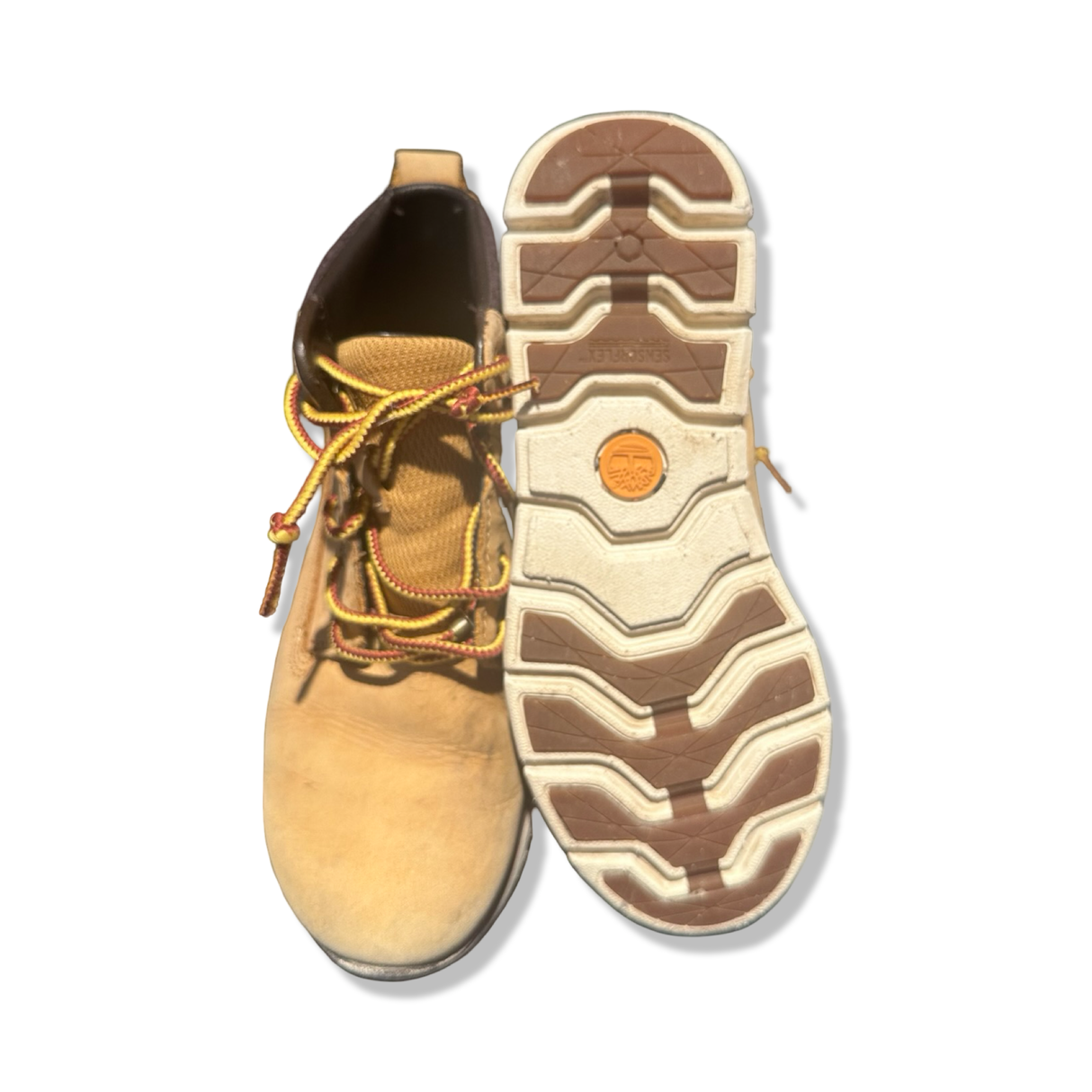 Brown Timberland women's boots, shown from above with one sole turned upward against a white background.