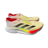Men's Adidas Adizero Boston 12 running shoes with black stripes, red heel collar, and yellowish midsole on white background.