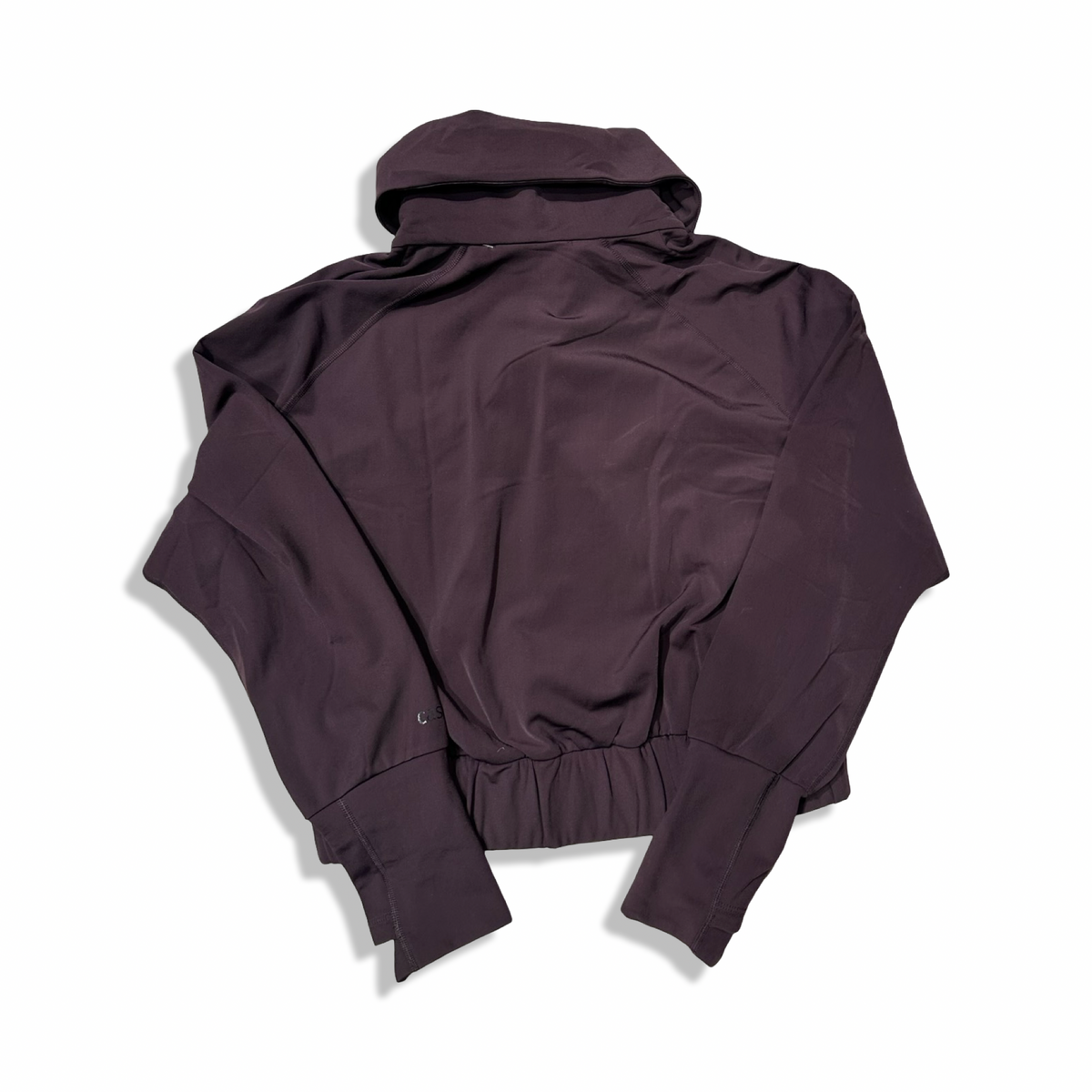 Baksidan av en vinröd träningsjacka Casall Warm Training Jacket för dam, fotograferad mot en vit bakgrund.