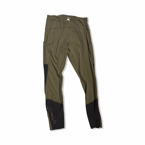 Green Norröna women's training tights with black details, front view against a white background.