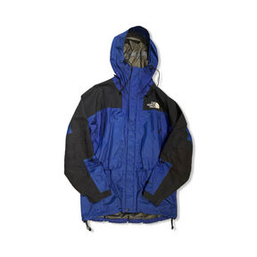 Blue and black The North Face men's hooded shell jacket, front view against a white background.