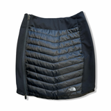 Black The North Face women's insulated skirt with side zipper, front view against a white background.