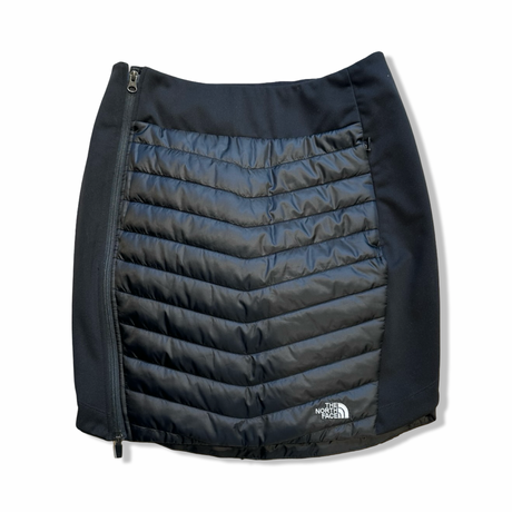 Black The North Face women's insulated skirt with side zipper, front view against a white background.