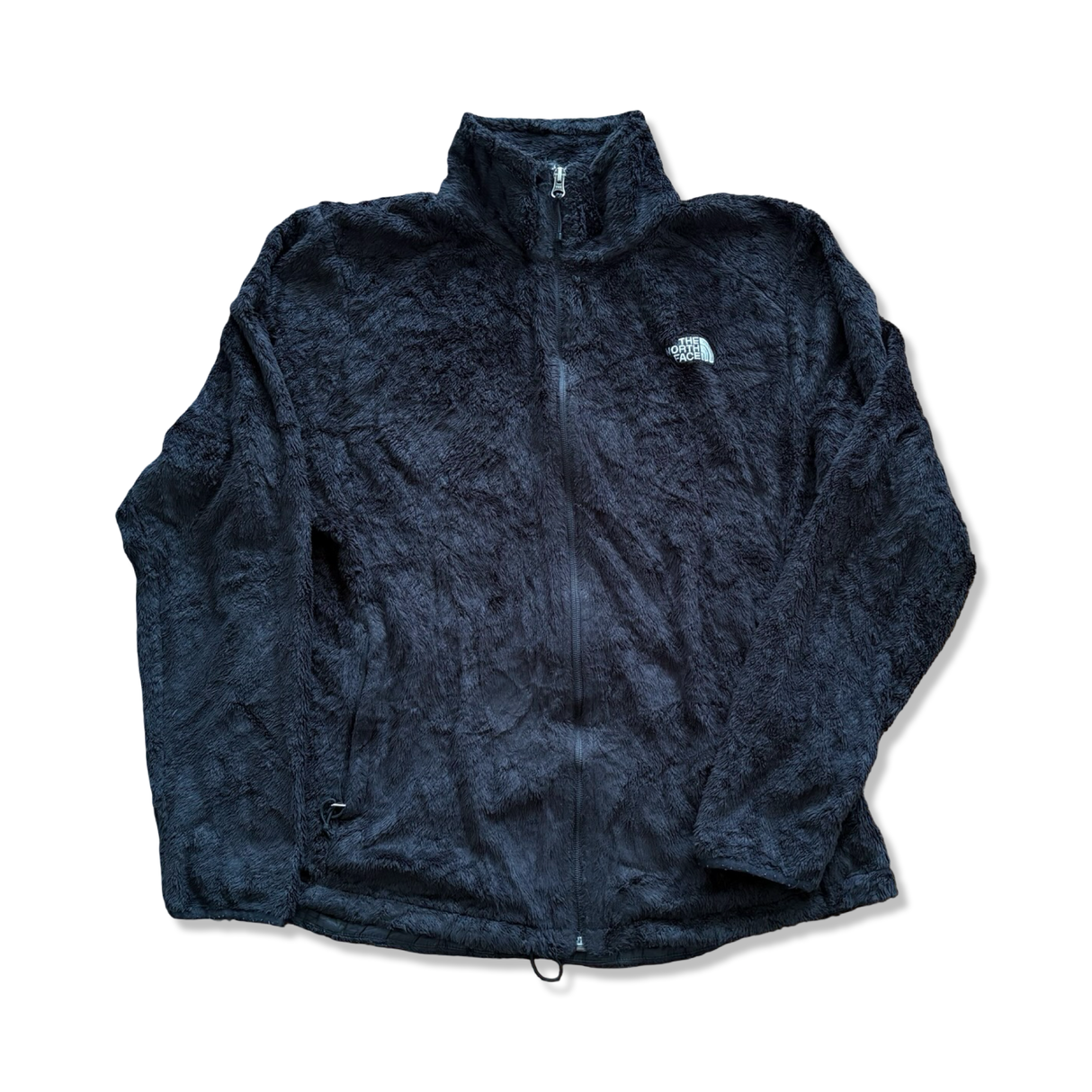 Svart fleececardigan för dam från The North Face med dragkedja och hög krage, fotograferad framifrån mot vit bakgrund.