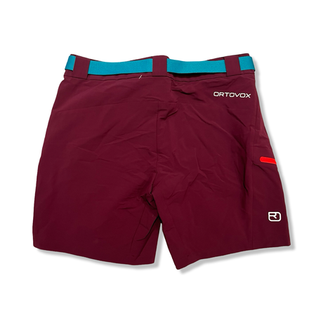 Back view of a purple Ortovox women's hiking shorts with a blue belt against a white background.