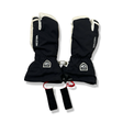 A pair of black and white Hestra three-finger gloves with wrist straps, front view against a white background.