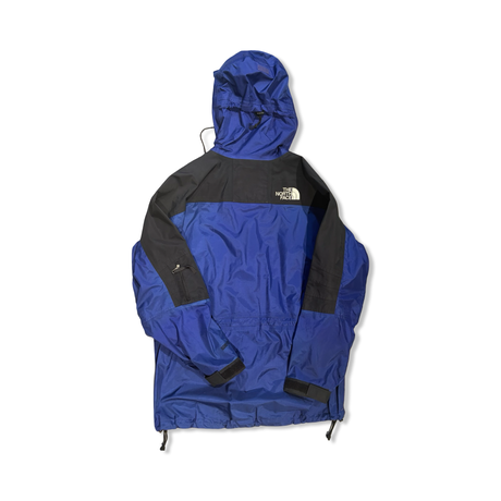 Back view of a blue and black The North Face men's shell jacket against a white background.