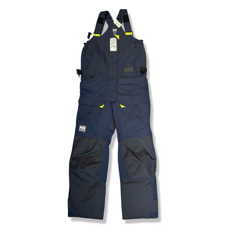 Mörkblå seglarbyxa Helly Hansen Skagen offshore för dam med hängslen, fotograferad framifrån mot en vit bakgrund.