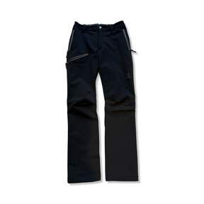 Black Haglöfs softshell pants for kids with zippered pockets, front view against a white background.
