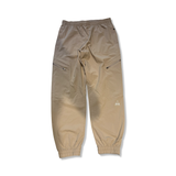Women's SOS Fujiyama functional trousers in beige with zipper details, front view against a white background.
