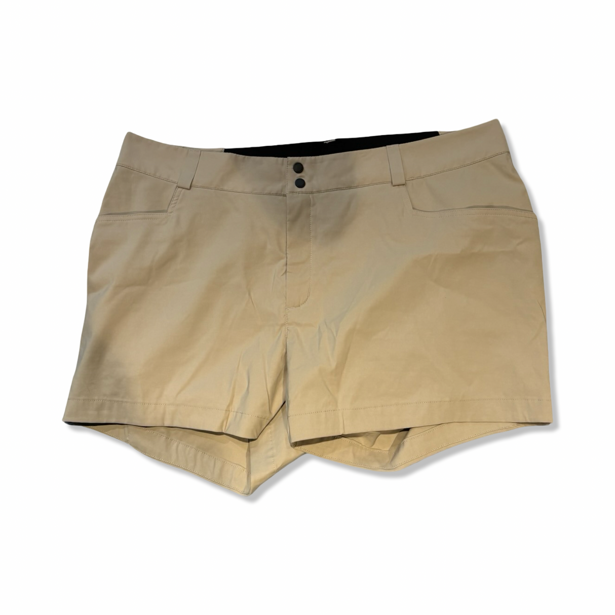 Peak Performance hiking shorts in beige, front view against a white background.