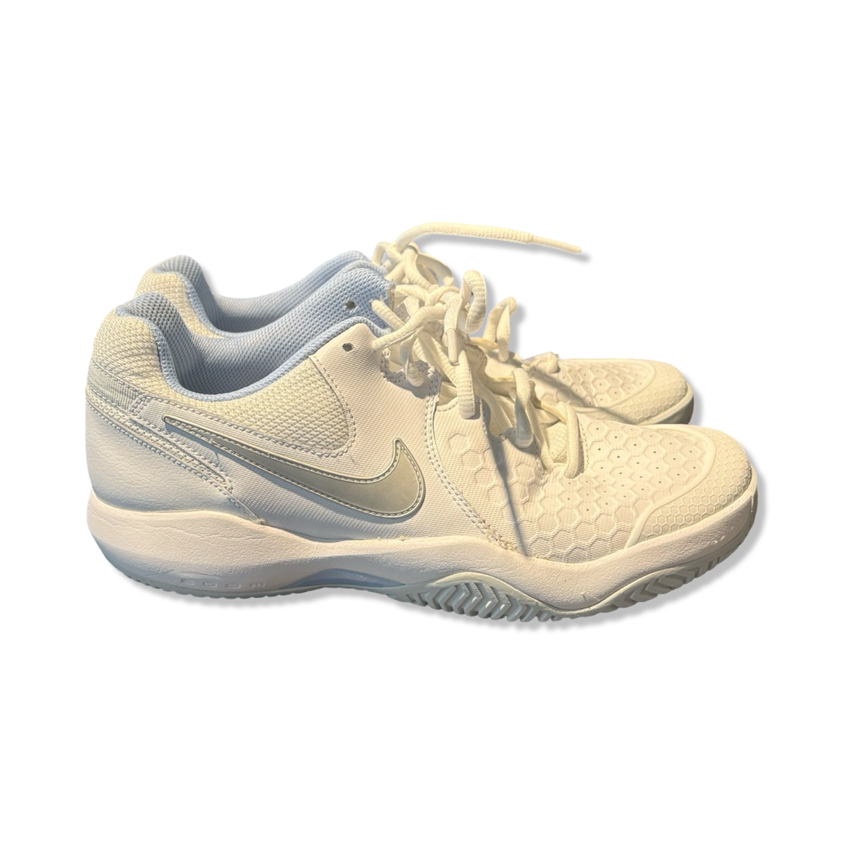 White Nike women's running shoes with laces and cushioned soles, side view on a white background.