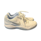 White Nike women's running shoes with laces and cushioned soles, side view on a white background.